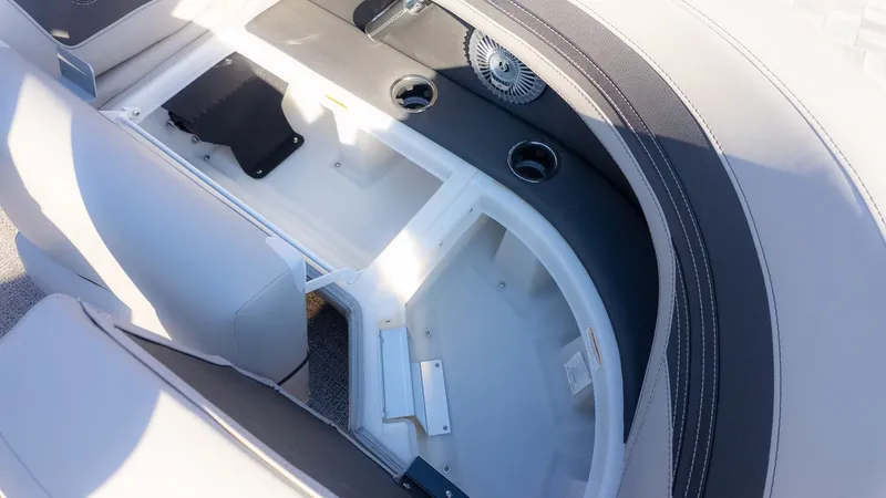 Slide: The Image of Interior view of a Barletta Corsa X23U boat with seating area and storage compartment. - 17