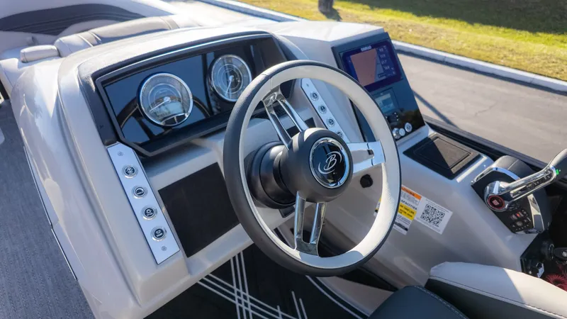 Slide: The Image of The image shows the helm of a Barletta Corsa X23U boat with modern instruments. - 23