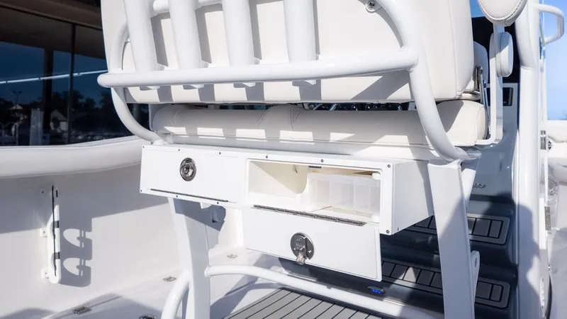 Slide: The Image of Tidewater 256 CC Adventure 2026: White cockpit with storage compartments under the seating. - 13