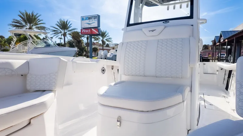 Slide: The Image of The image shows the cockpit of a Tidewater 256 CC Adventure boat with white upholstery. - 25