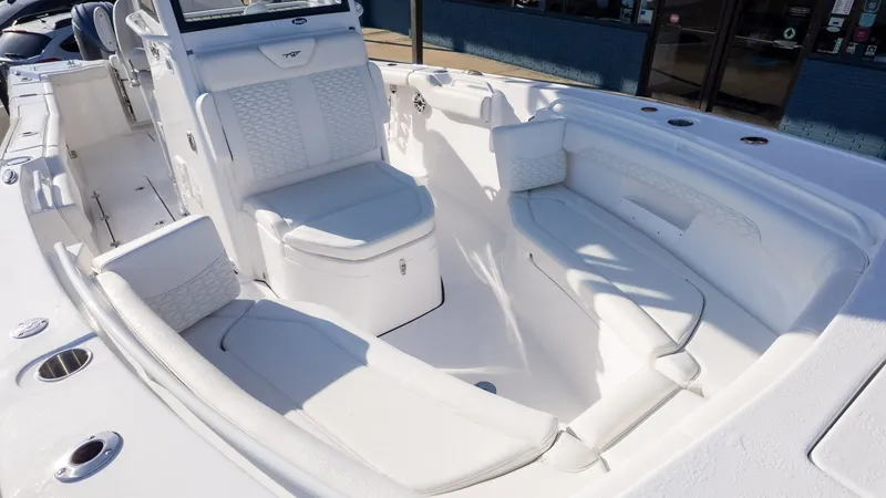 Slide: The Image of The image shows the cockpit of a Tidewater 256 CC Adventure boat with white upholstery. - 20