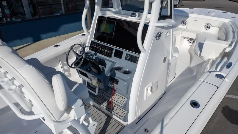 Slide: The Image of The image shows the cockpit of a Tidewater 256 CC Adventure boat with modern features. - 16