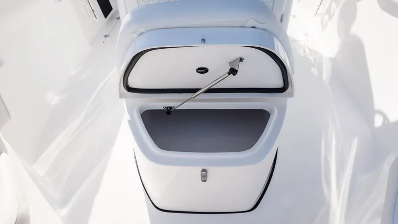 Slide: The Image of An open storage compartment on a boat with a white interior. - 24