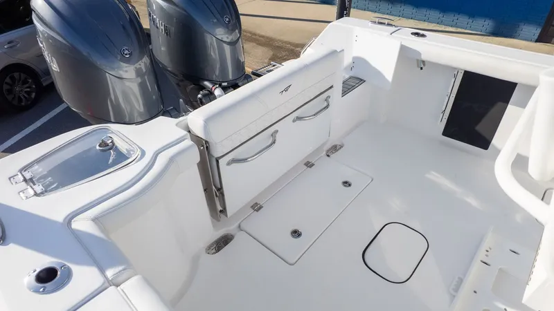 Slide: The Image of The image shows the cockpit of a Tidewater 256 CC Adventure boat with twin outboard engines. - 8
