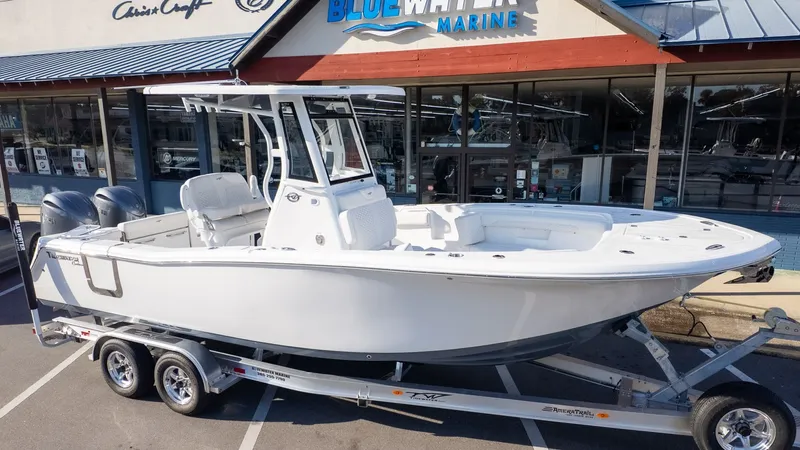 Slide: The Image of Tidewater 256 CC Adventure 2026 on a trailer in front of a marine store. - 28