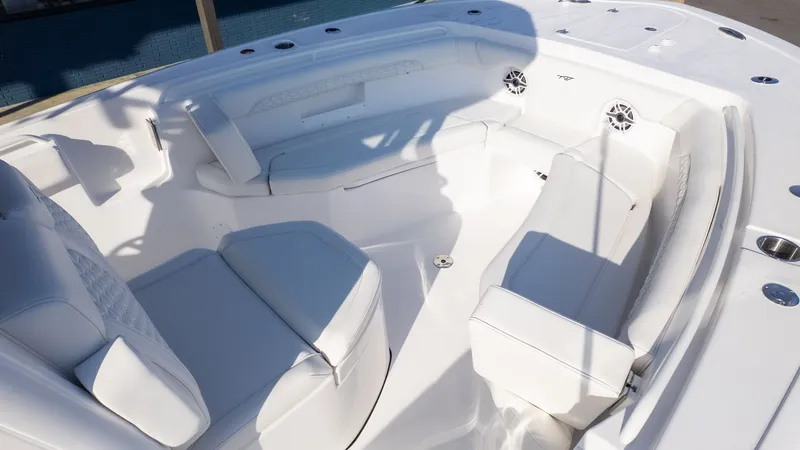 Slide: The Image of The image shows the interior of a 2026 Tidewater 256 CC Adventure boat with white upholstery. - 17