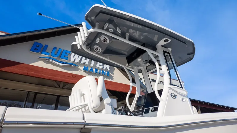 Slide: The Image of A modern boat with a sleek helm station in front of a building labeled "Bluewater Marine." - 27