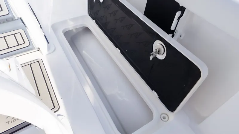 Slide: The Image of An open storage compartment on a boat with a black lid and a lock. - 6