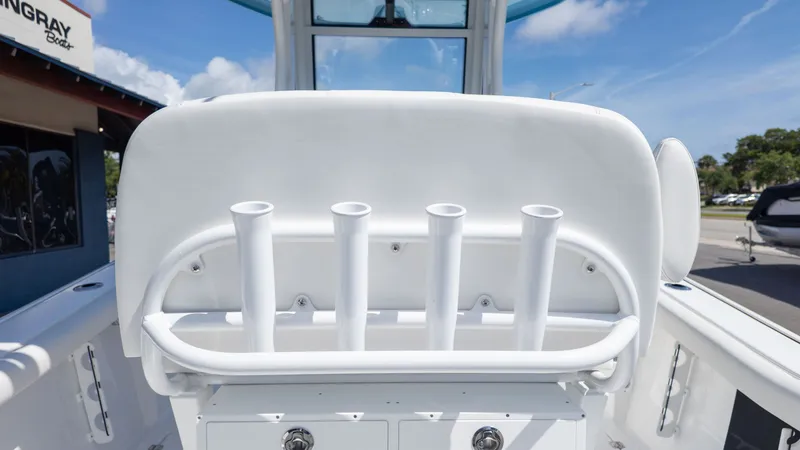 Slide: The Image of Rear view of a white boat with four fishing rod holders and blue sky in the background. - 8