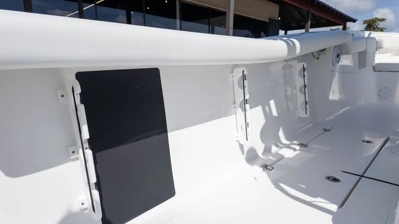 Slide: The Image of The image shows the deck of a Tidewater 256 CC Adventure boat with white surfaces. - 9