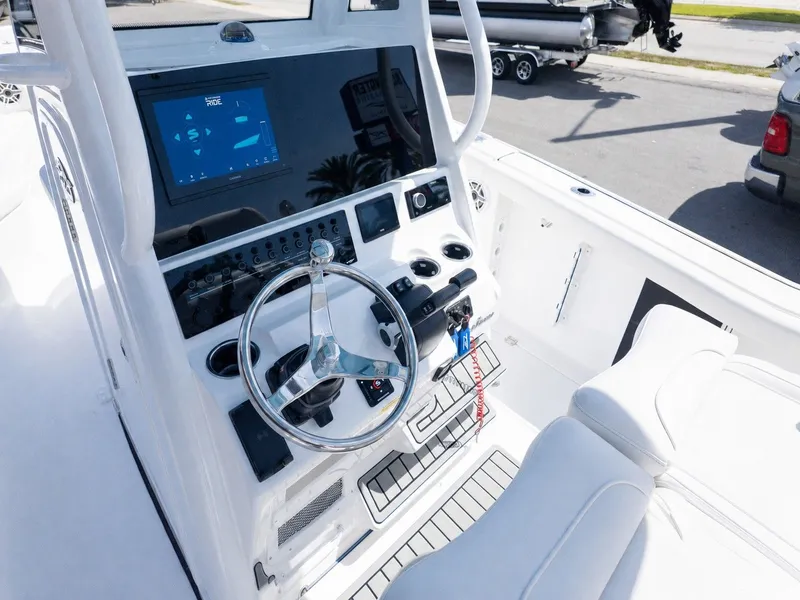 Slide: The Image of The image shows the helm of a Tidewater 256 CC Adventure boat with modern instruments. - 22