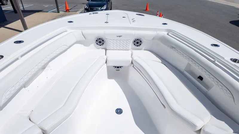 Slide: The Image of The image shows the bow area of a Tidewater 256 CC Adventure boat with white seating. - 16