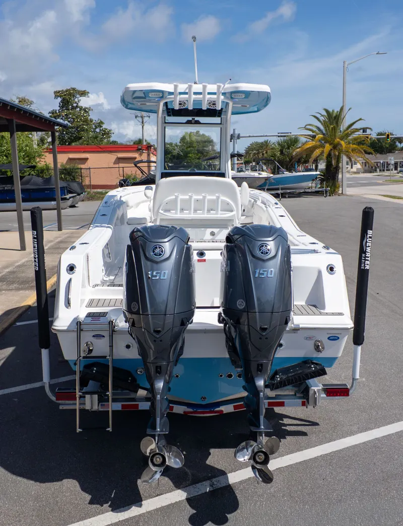 Slide: The Image of The image shows a Tidewater 256 CC Adventure boat with twin outboard engines in a parking lot. - 4
