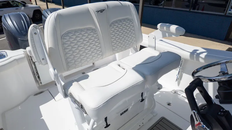 Slide: The Image of The Tidewater 256 CC Adventure features luxurious white upholstered seats with a quilted pattern. - 19