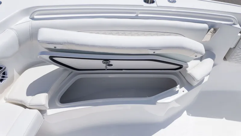 Slide: The Image of The image shows a white bench seat with storage underneath on a boat. - 14