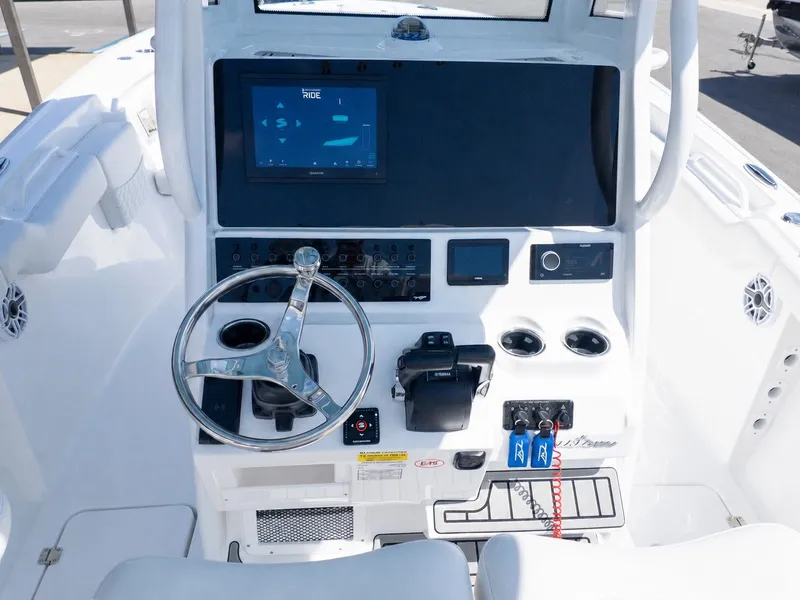 Slide: The Image of Helm of the 2026 Tidewater 256 CC Adventure with steering wheel and electronics. - 20