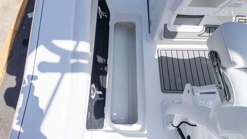 Slide: The Image of The image shows the deck of a Tidewater 256 CC Adventure boat with storage and seating area. - 9