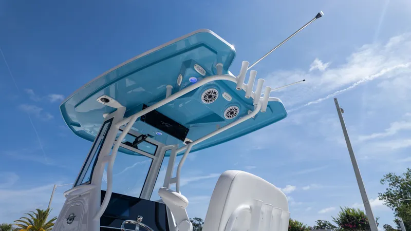 The Image of The image shows the hardtop of a Tidewater 256 CC Adventure boat with speakers and rod holders. - 1