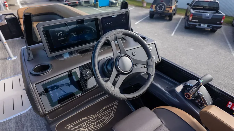 Slide: The Image of The image shows the helm of a Bennington 26 M STERN LOUNGE boat with modern instruments. - 24