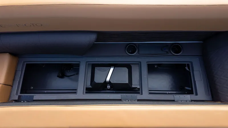 Slide: The Image of Interior view of a boat with three storage compartments and brown upholstery. - 20