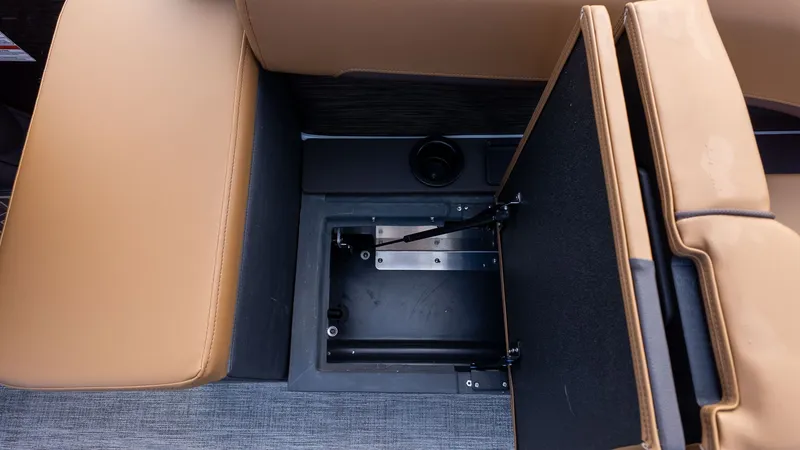 Slide: The Image of An open storage compartment in a boat's seating area with brown upholstery. - 10