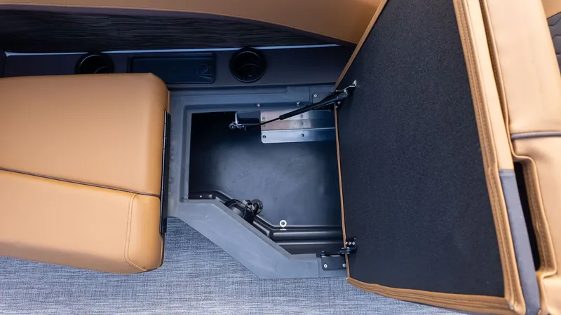 Slide: The Image of Open storage compartment with brown upholstery and gray flooring. - 11