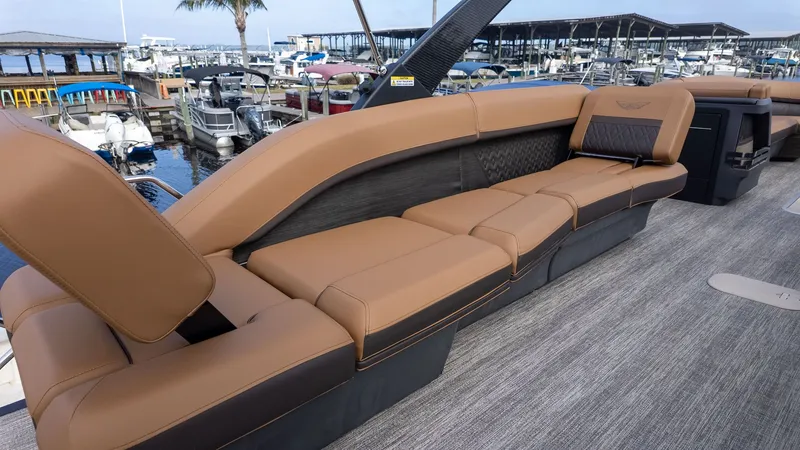 Slide: The Image of Luxurious brown seating on a modern boat, overlooking a marina filled with boats. - 6
