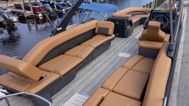 Slide: The Image of The image shows a luxury pontoon boat with beige leather seating and a modern helm station. - 4