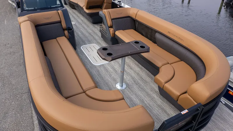 Slide: The Image of Bennington 26 M STERN LOUNGE 2026: Luxurious seating area with brown upholstery on a boat. - 15