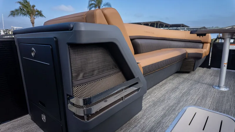 Slide: The Image of Luxurious seating area on a modern boat with gray flooring and palm trees in the background. - 14