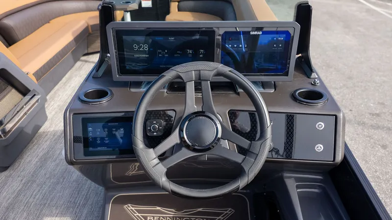 Slide: The Image of The dashboard of a modern boat with multiple screens and a steering wheel. - 23