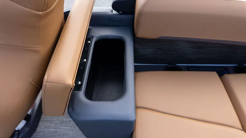 Slide: The Image of Close-up of a seating area with brown upholstery and a black storage compartment. - 10
