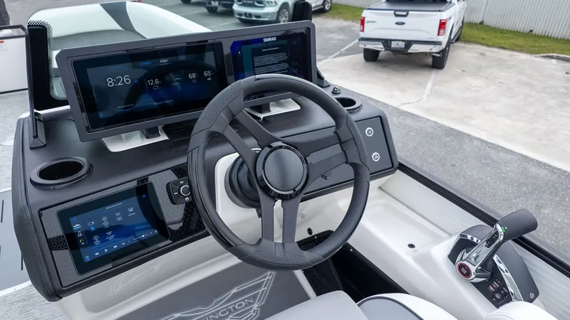 Slide: The Image of The image shows the helm of a Bennington 26 M STERN LOUNGE boat with modern instruments. - 21