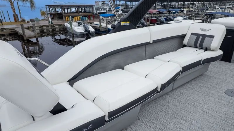 Slide: The Image of The image shows a luxurious white seating area on a boat docked at a marina. - 6