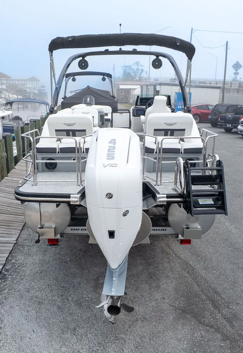Slide: The Image of The image shows a 2026 Bennington 26 M STERN LOUNGE boat with a large outboard motor. - 3