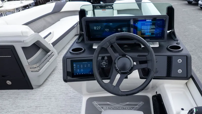 Slide: The Image of The image shows the helm of a Bennington 26 M STERN LOUNGE boat with modern displays. - 22