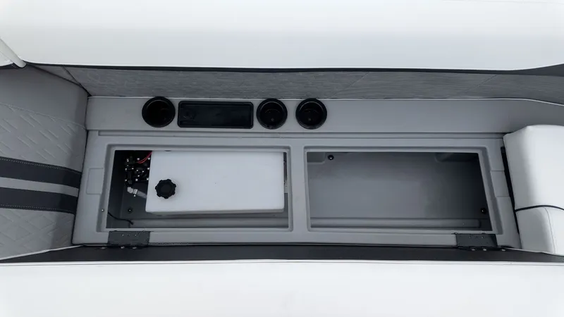 Slide: The Image of Interior view of a boat with gray and white upholstery and cup holders. - 10