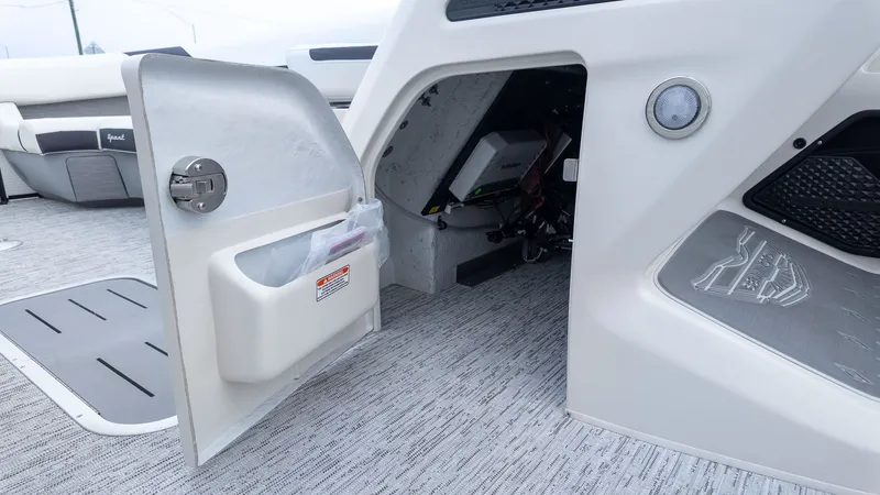 Slide: The Image of An open storage compartment on a Bennington 26 M STERN LOUNGE boat, showing interior and accessories. - 18