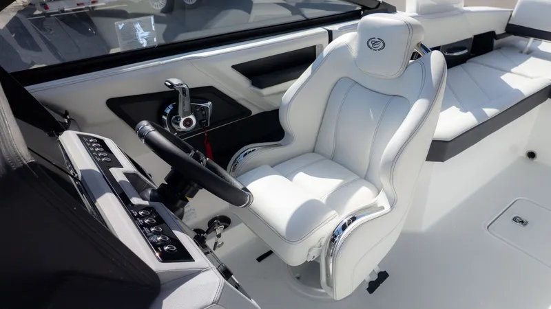 Slide: The Image of The image shows the helm of a Cobalt R6 boat with a luxurious white captain's chair. - 26