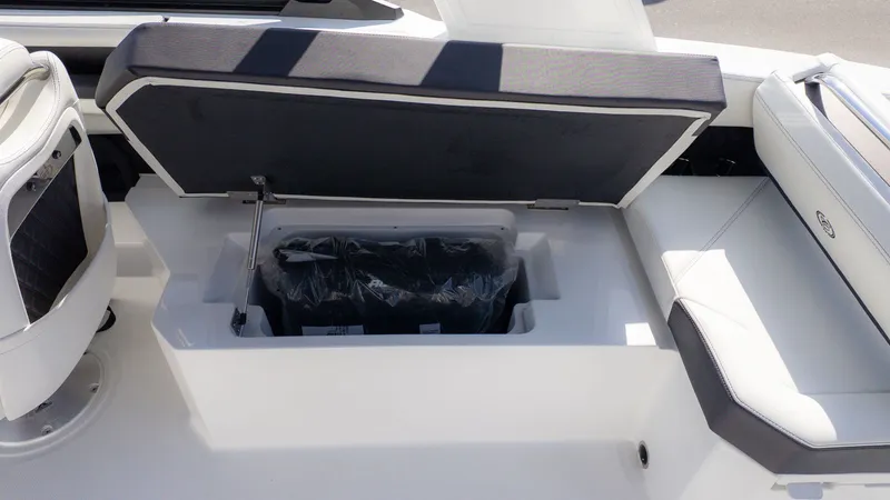 Slide: The Image of An open storage compartment on a Cobalt R6 boat, revealing a black container. - 5