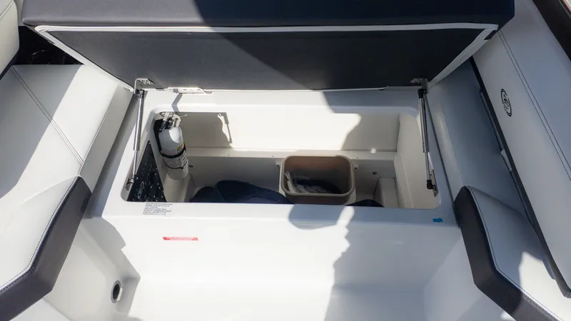 Slide: The Image of An open storage compartment at the stern of a Cobalt R6 boat with a fire extinguisher. - 11