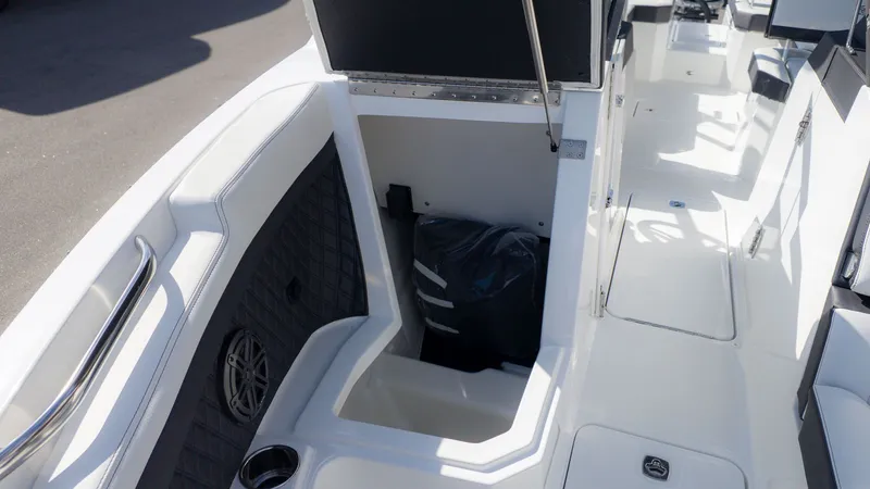 Slide: The Image of The image shows the cockpit of a Cobalt R6 boat with white upholstery and storage space. - 24
