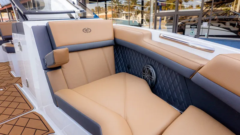 Slide: The Image of The image shows the interior of a 2026 Cobalt R6B boat with beige and gray seating. - 20