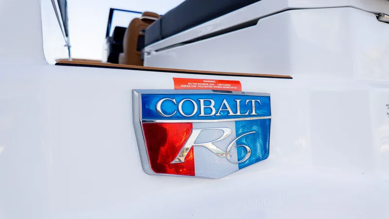 Slide: The Image of Close-up of the Cobalt R6B emblem on a white boat. - 31