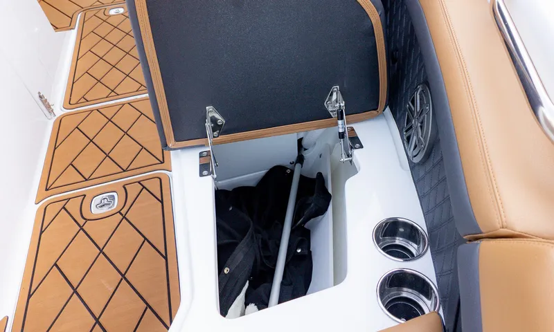 Slide: The Image of The image shows the storage area of a 2026 Cobalt R6B boat with brown upholstery. - 21