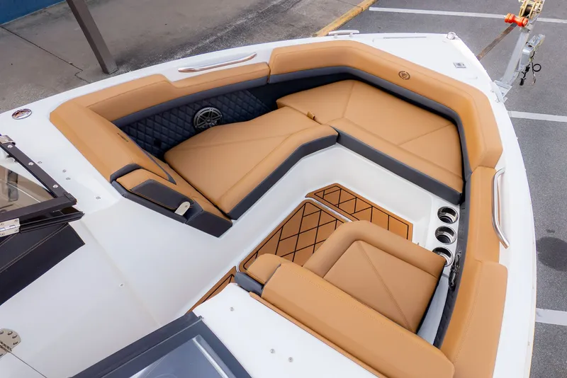 Slide: The Image of The image shows the bow area of a Cobalt R6B boat with beige upholstery. - 5