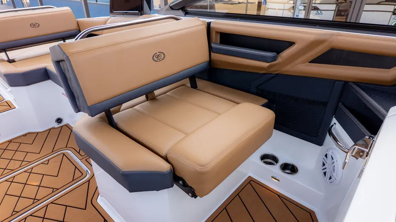 Slide: The Image of Interior of a Cobalt R6B boat with beige leather seating and modern armrests. - 15