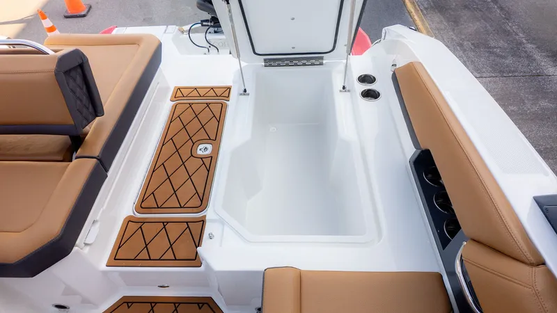 Slide: The Image of The image shows the cockpit of a Cobalt R6B boat with brown seating and an open storage compartment. - 12