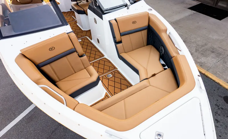 Slide: The Image of The image shows the bow area of a Cobalt R6B boat with luxurious brown upholstered seats. - 18