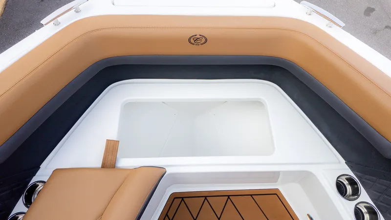Slide: The Image of The image shows the bow area of a Cobalt R6B boat with brown upholstery and cup holders. - 21
